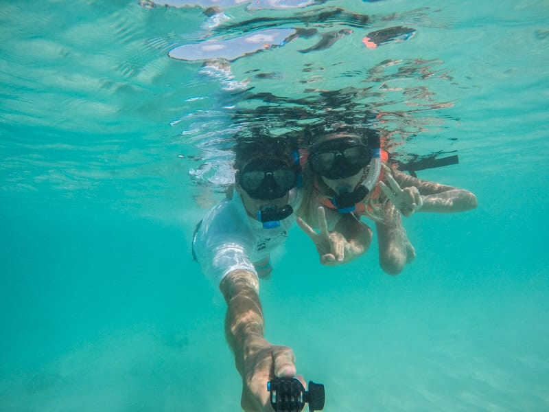 people snorkeling in clear water