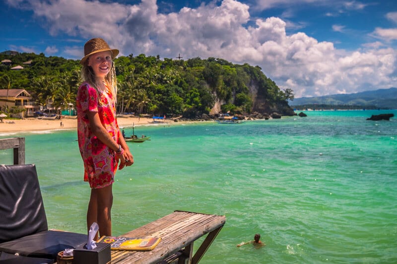 girl standing on edge of platform looking at beach