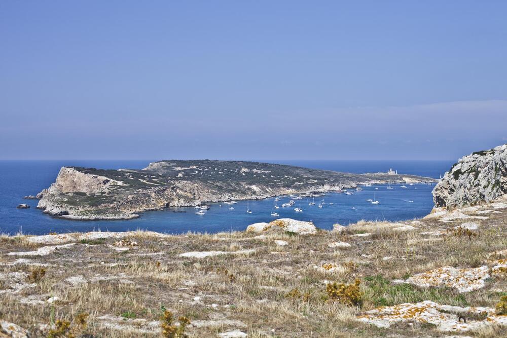 island off mainland with boats moored