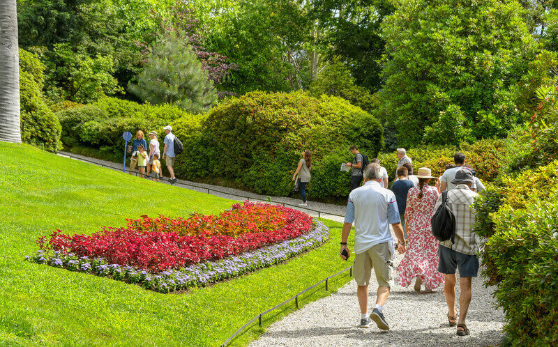 people walking through garden