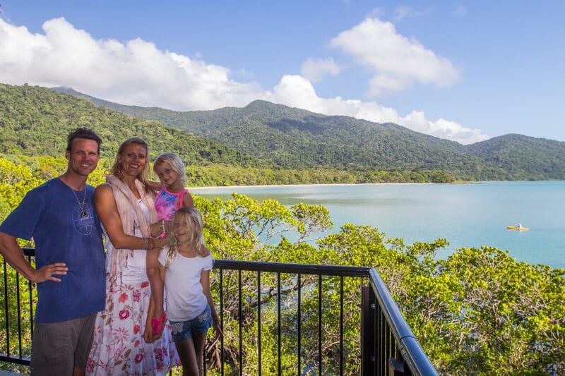 family posing with view of Cape Tribulation and  Daintree Rainforest