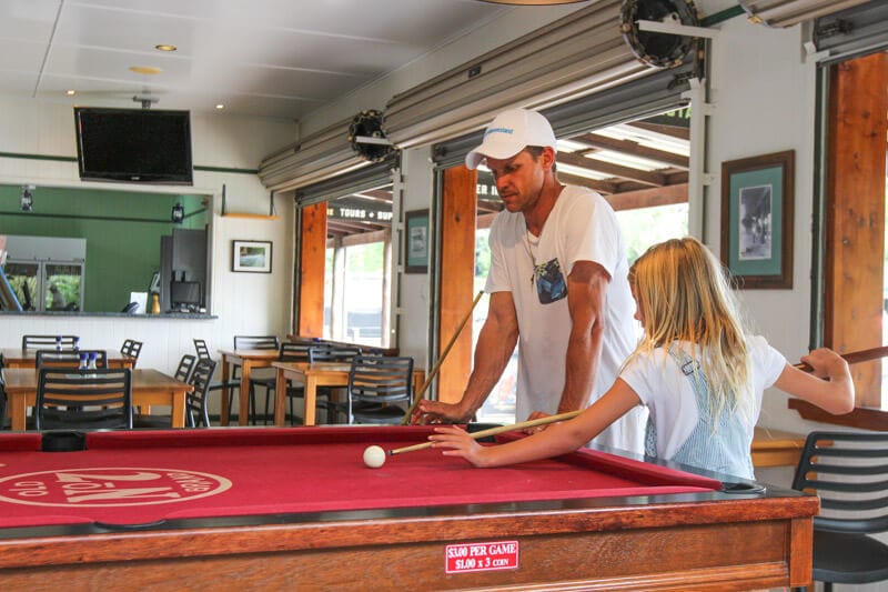 man and girl playing snooker