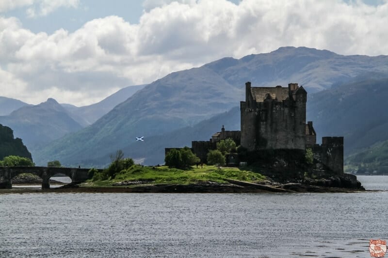 an island next to mountains