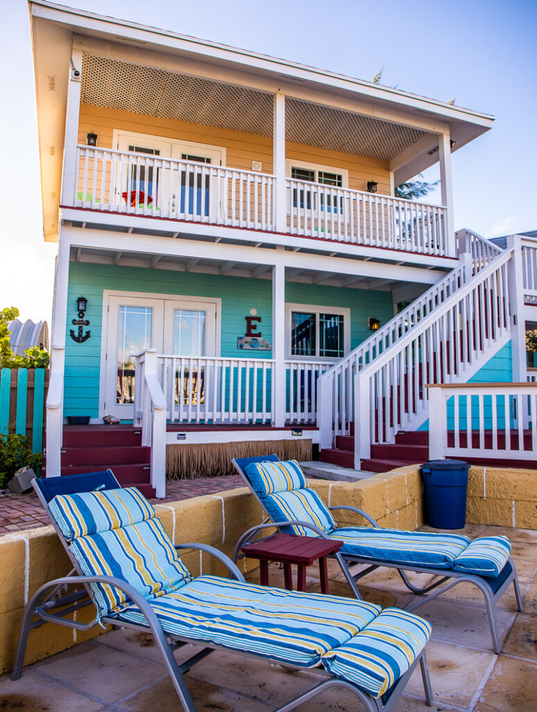 Pool chairs in front of a 2 story villa