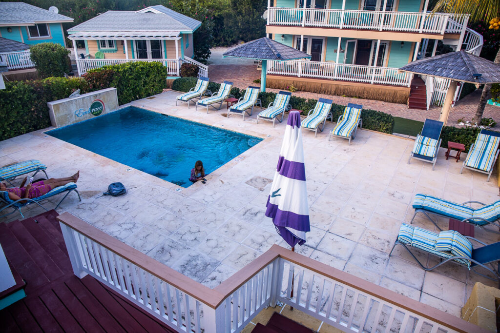 Girl in a pool at a resort surrounded by villas