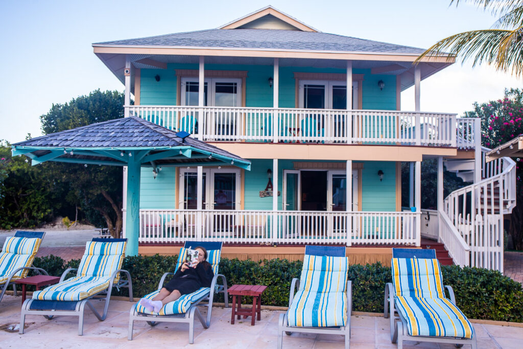 Pool chairs in front of a 2-story villa