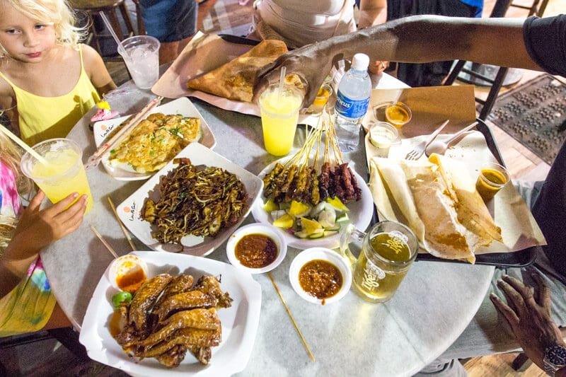 table on Boon Tat Street full of food