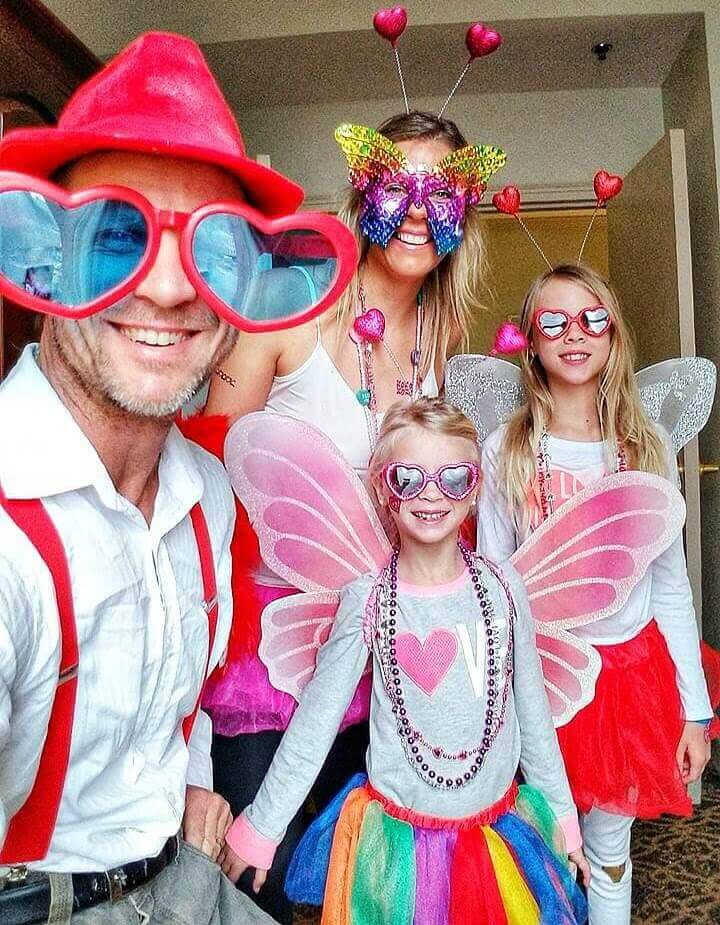 family posing in fair costumes and butterfly masks