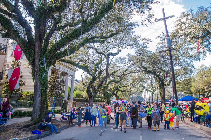 crowds walking down street in the Garden District in New Orleans during Mardi Gras