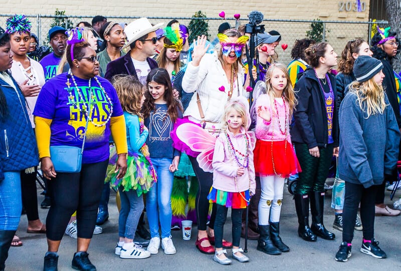 people in costumes Watching the parades at Mardi Gras