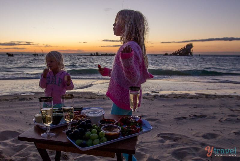 girls eating food on the beach