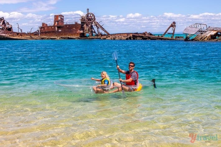 people kayaking in clear kayaks near Tangalooma Wrecks