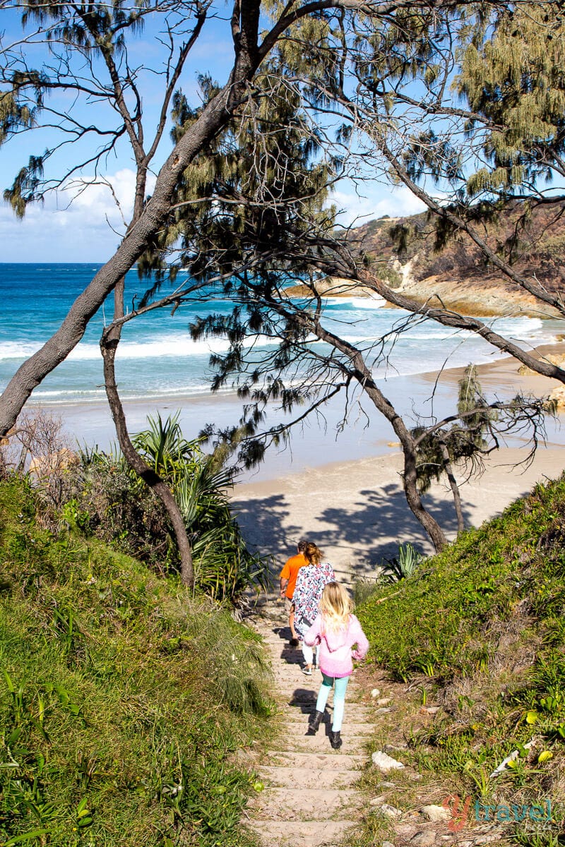 people walking down to sand at Honeymoon Bay on Moreton Island, Queensland