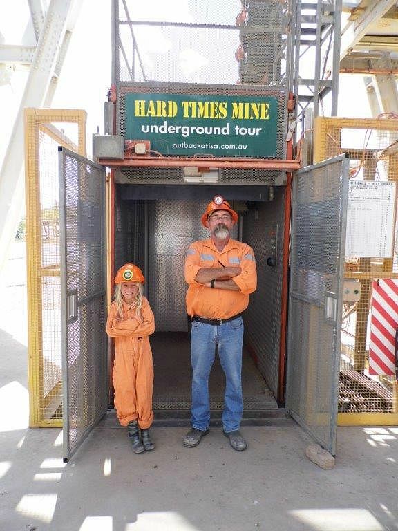 man and child posing in front of mine entrance