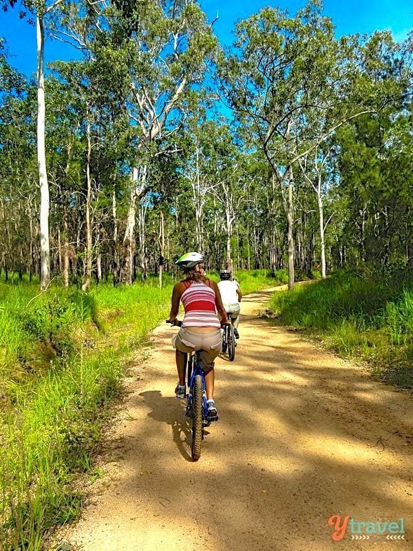 woman riding bike on dirt trail