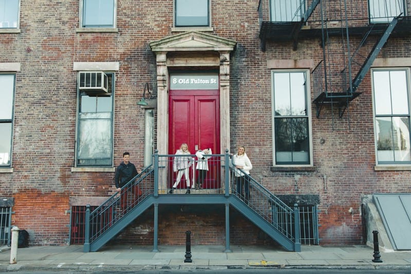 family posing on stairs to apartment Fulton st Brooklyn 