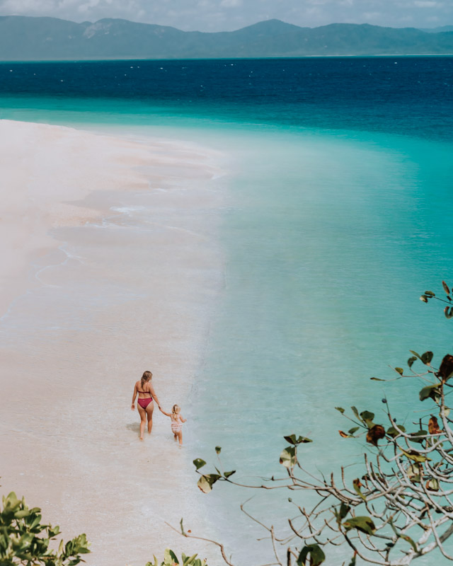 Mother and daughter walking along Nudey beach