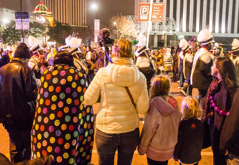 crowds on street watching marchin gband in Orpheus Parade 