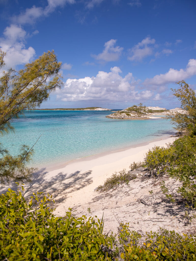 Beautiful blue water beach surrounded by white sand and small islands