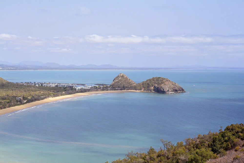 curving beach with rocky headland