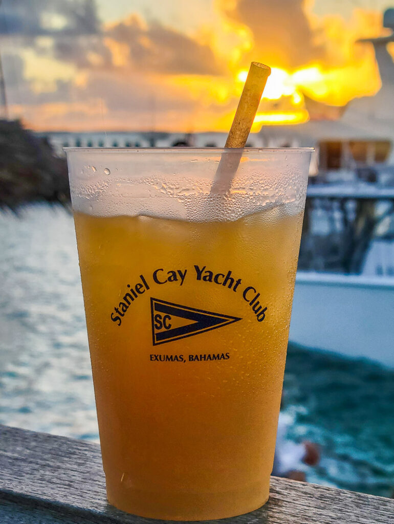 Cocktail glass with sunset in background