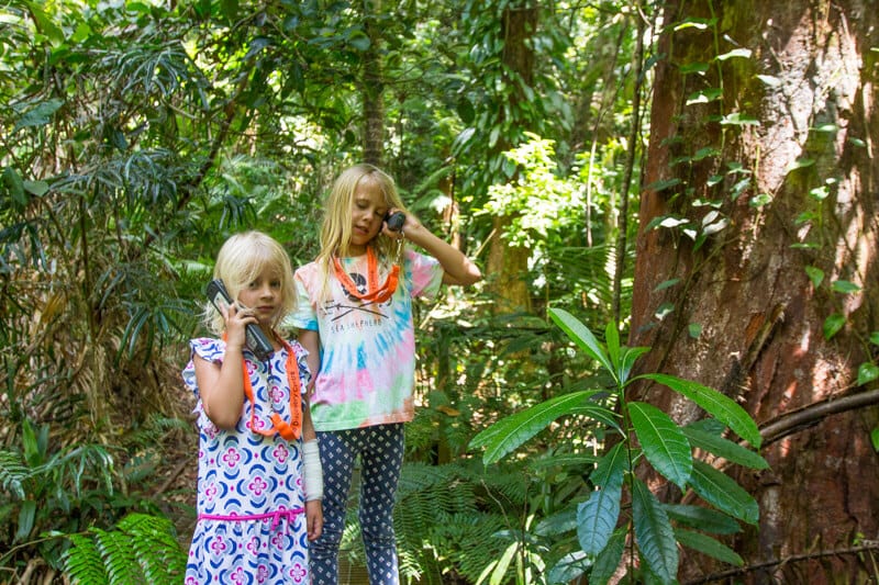 girls standing in a forest