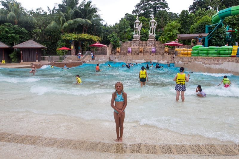 girl standing in front of wave pool