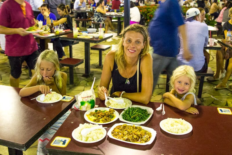 woman and girls eating at Newton Hawker Market 