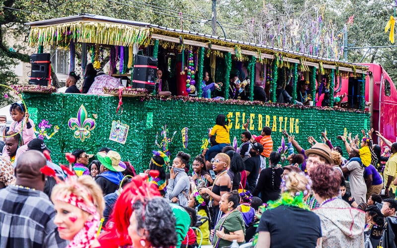 decorated truck throwing beads to crowd 