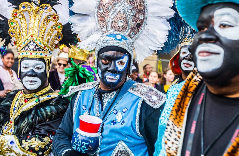 painted black and white faces of the krewe of zulu parade