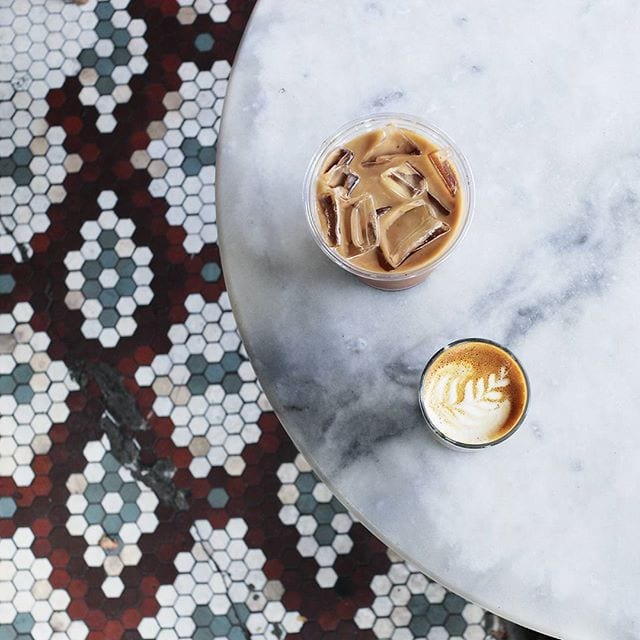 hot and cold latte on table