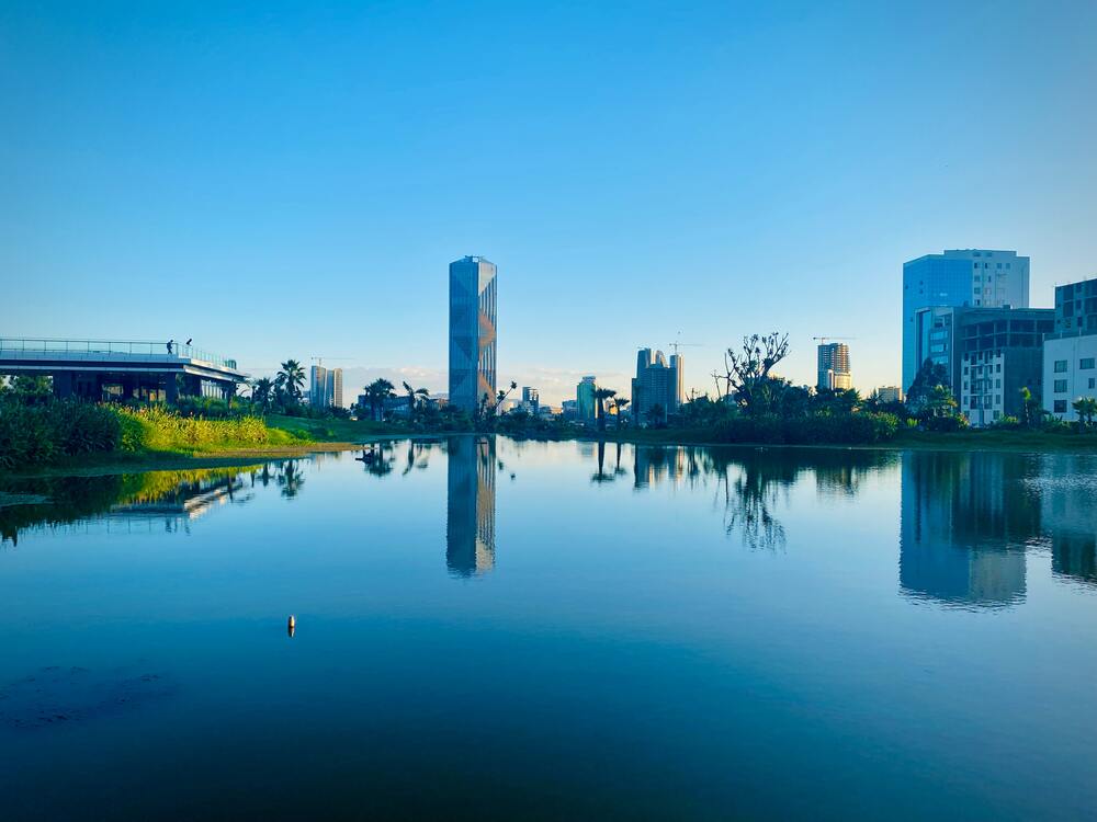 building on edge of lake and reflections