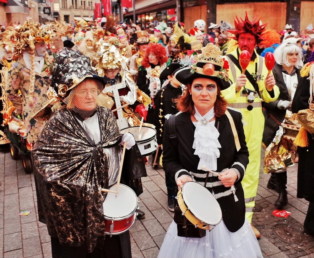 people in costumes in a street parade