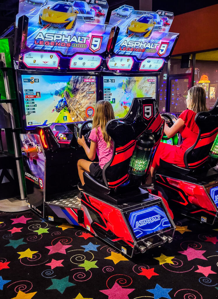 Mom and daughter playing a car racing game