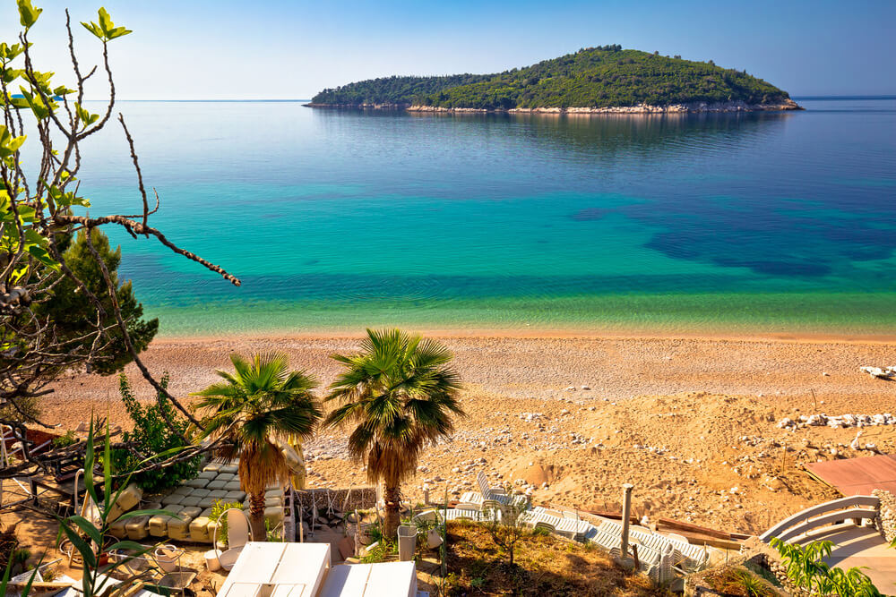 golden sand beach with lokrum  island in the distsance