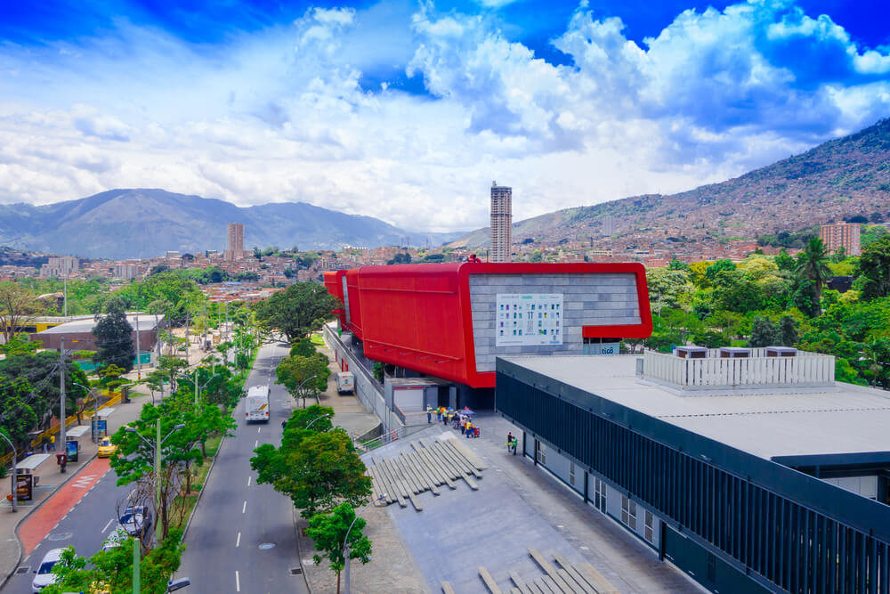 red building with views of mountains and city in thebackground