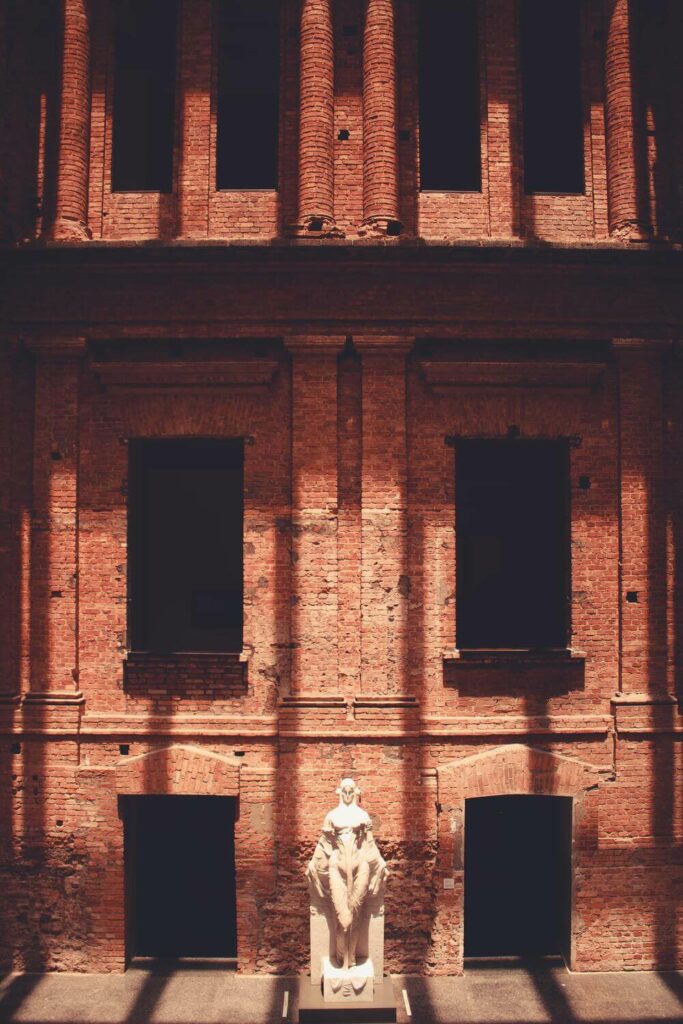 statue against brick wall