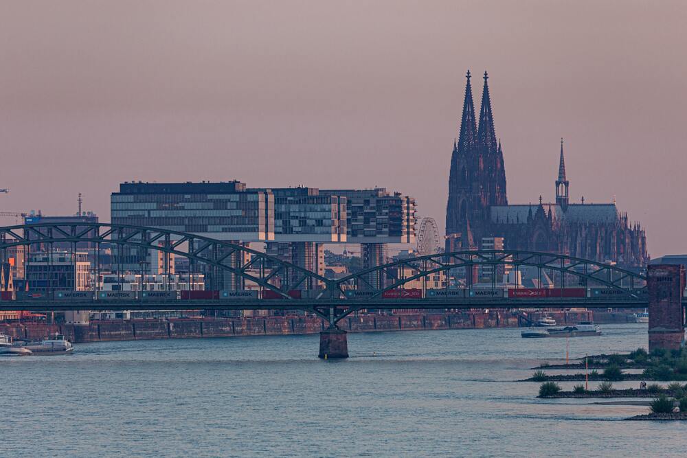 bridge crossing rhine river with buildings on the edge