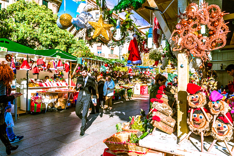 people walking past stalls at the Santa Llucia Fair i