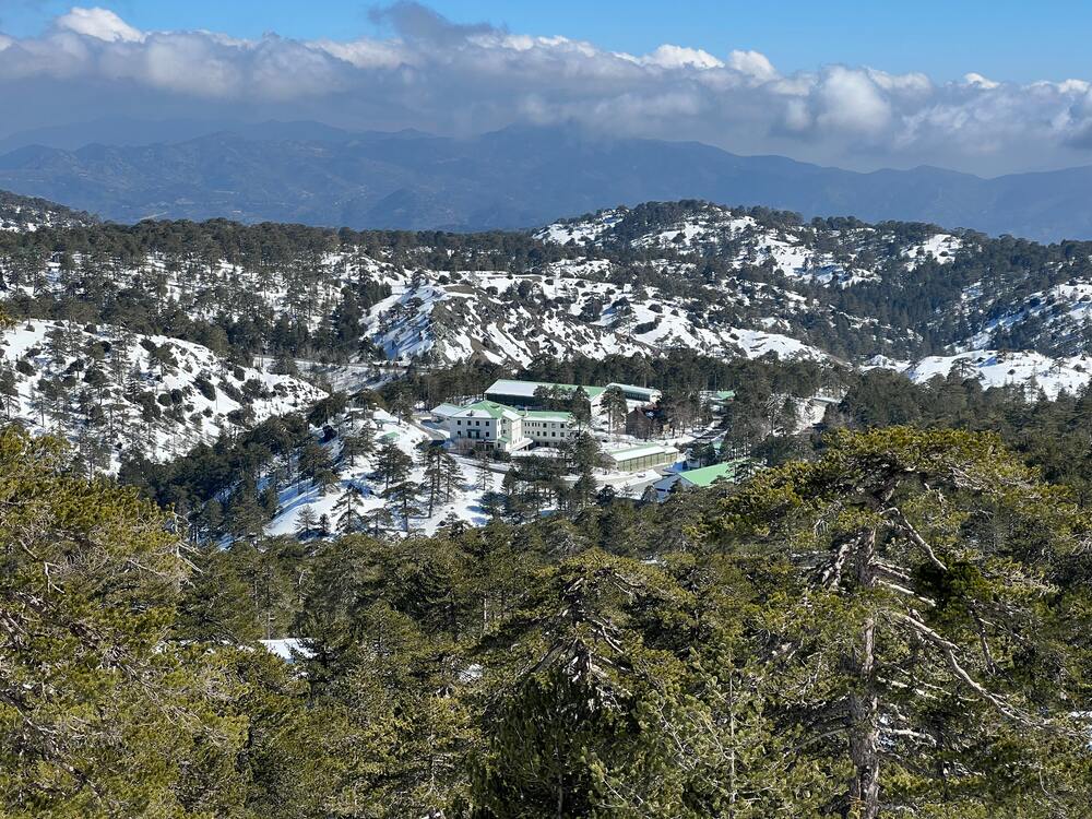 ski resort in the middle of snow capped mountains