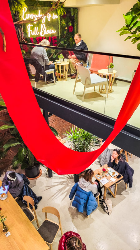 people sitting inside ariston flowers and cafe