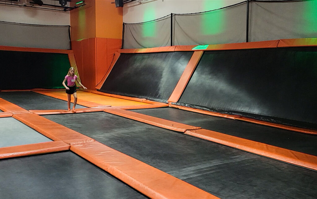 Girl at a large indoor trampoline park