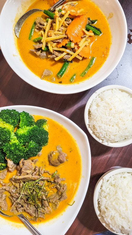 two bowls of thai curry on the table