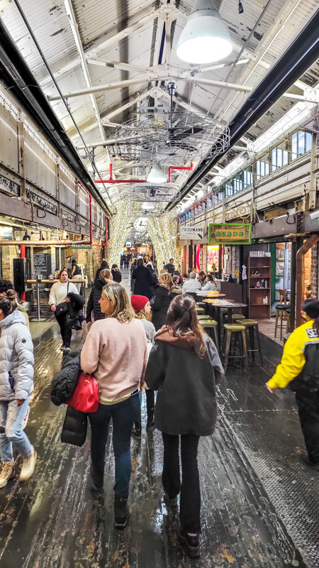 people walking through chelsea markets