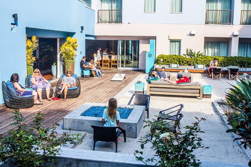 people sitting on chairs in kimpton courtyard