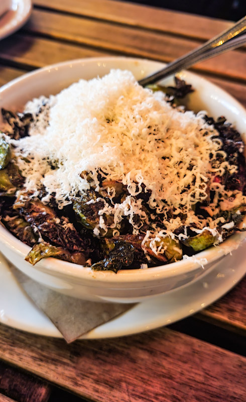 bowl of brussel sprouts with parmesan on top