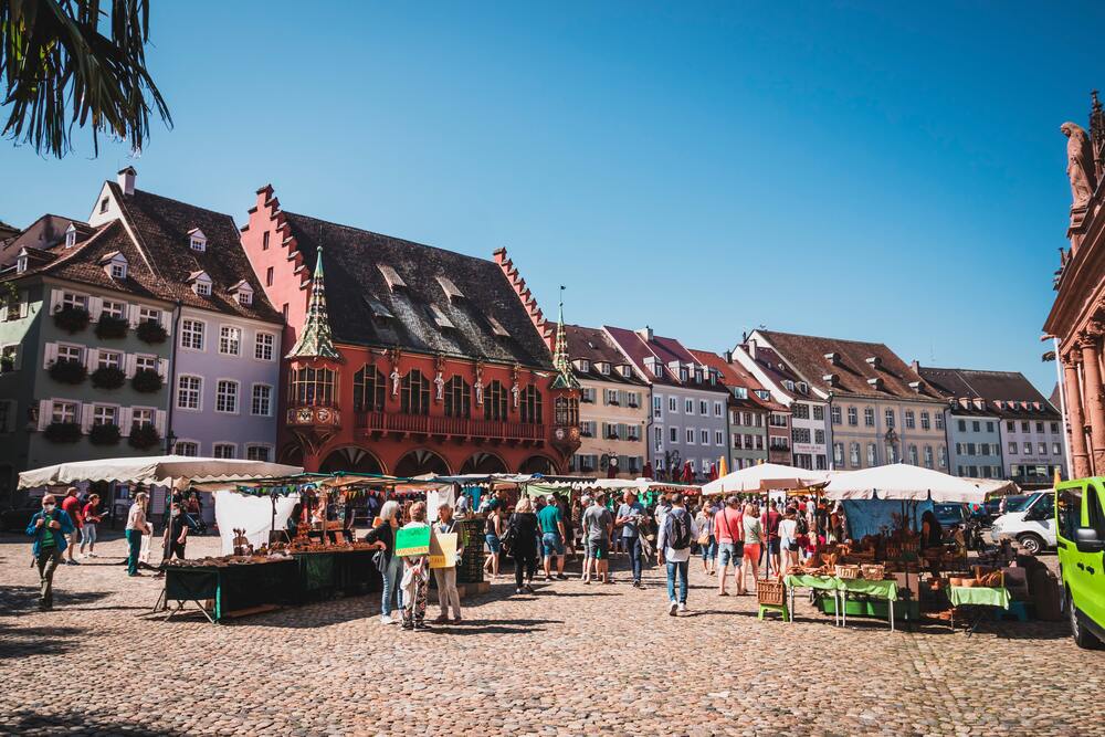 market stalls in front of colorful buildings