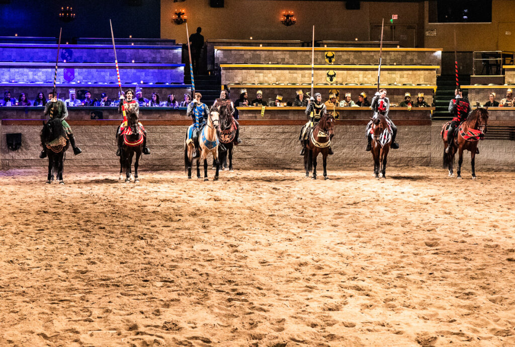 Men dressed in medieval costumes on horse back