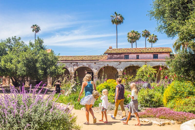 Family exploring the grounds of a mission