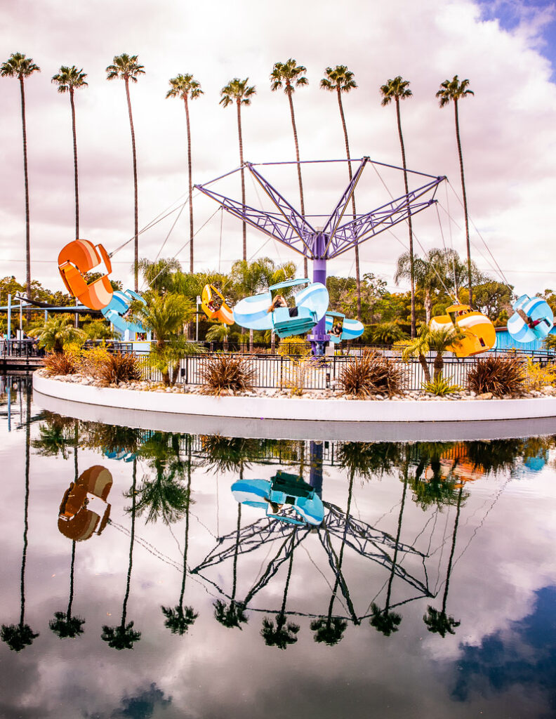 Kids ride at a theme park, model planes swinging around in a circle